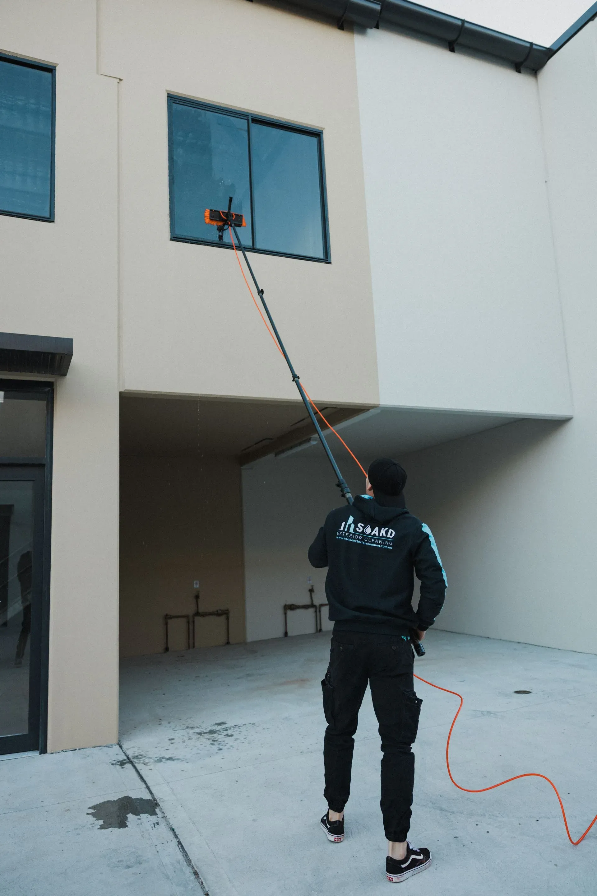 SOAKD operator using a reach pole to work at gutter-line height